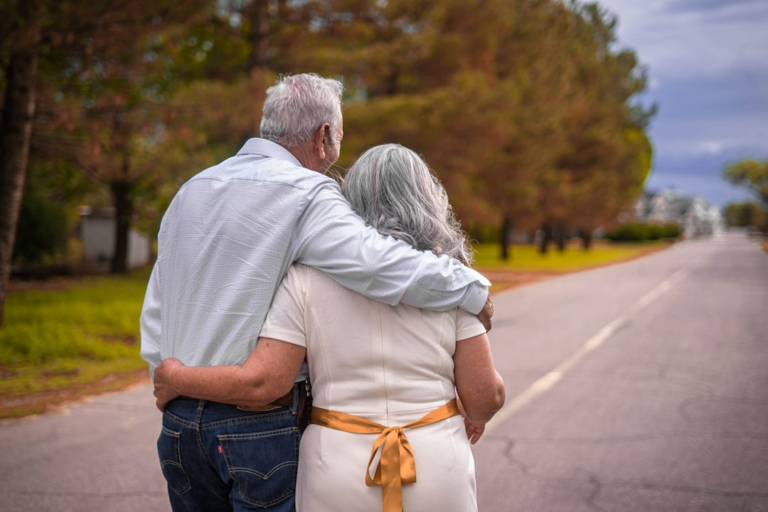 Older couple walking together outdoors